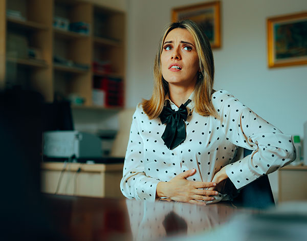 Stressed Woman Feeling Abdominal Pain at the Office stock photo Inflammatory Bowel Disease, Emotional Stress, Healthcare And Medicine, Irritable Bowel Syndrome, Abdomen