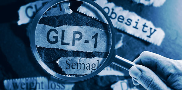 GLP-1 related drugs newspaper headlines with hand and magnifying glass