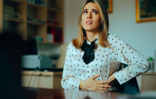 Stressed Woman Feeling Abdominal Pain at the Office stock photo Inflammatory Bowel Disease, Emotional Stress, Healthcare And Medicine, Irritable Bowel Syndrome, Abdomen