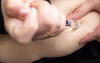 Person Administering a Semaglutide Injection for Weight Management