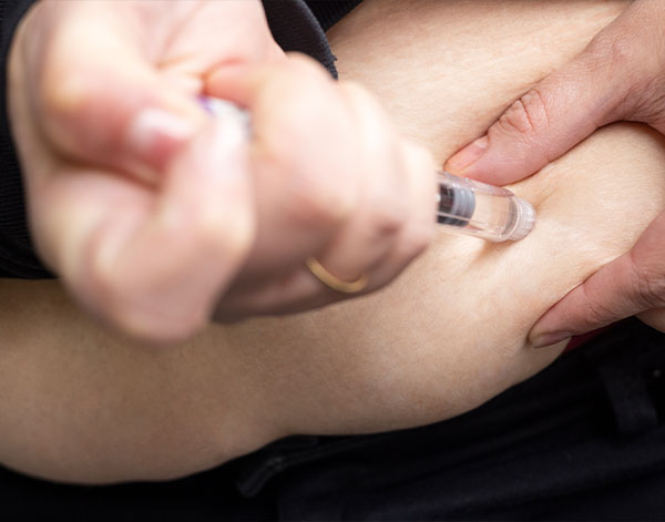 Person Administering a Semaglutide Injection for Weight Management